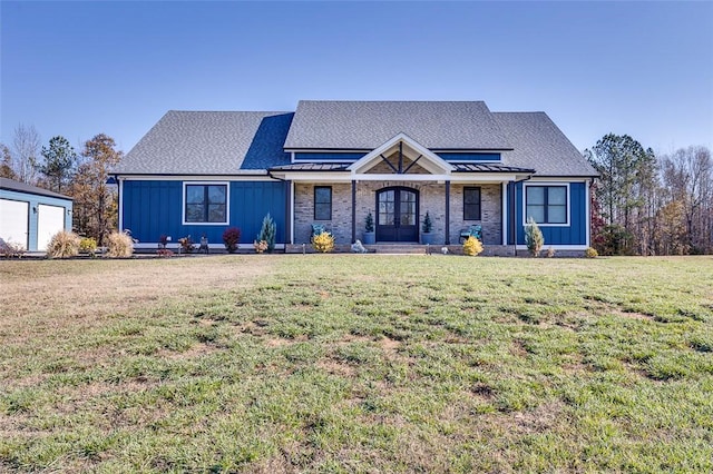 view of front of house with metal roof, a standing seam roof, french doors, board and batten siding, and a front yard