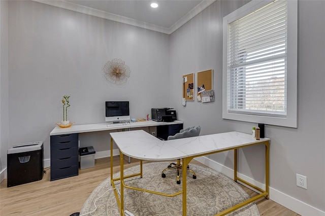 office area with light wood finished floors, baseboards, and crown molding