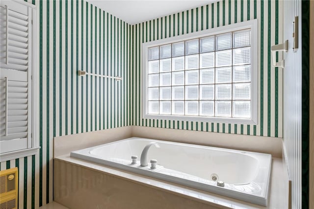 bathroom featuring a whirlpool tub and wallpapered walls