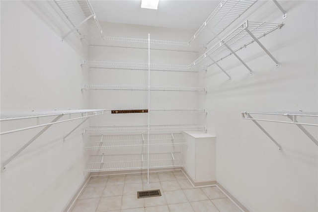 spacious closet featuring tile patterned flooring and visible vents