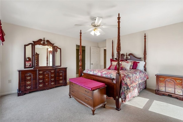 bedroom featuring light carpet, a ceiling fan, and baseboards