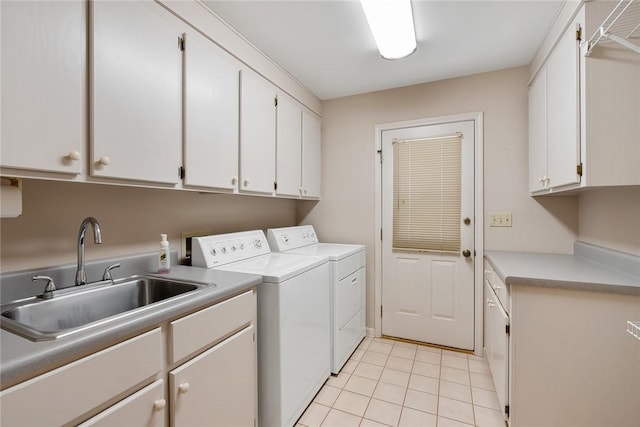 laundry room featuring cabinet space, a sink, washing machine and clothes dryer, and light tile patterned floors