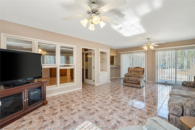 living area with ceiling fan, built in features, and baseboards