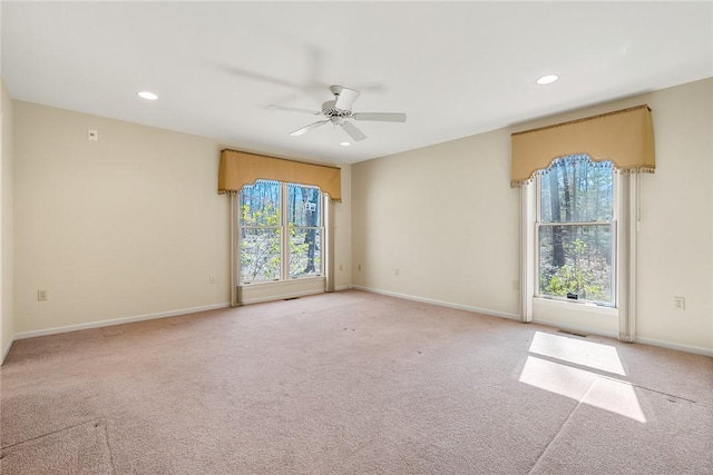 spare room featuring light carpet, baseboards, a ceiling fan, and recessed lighting