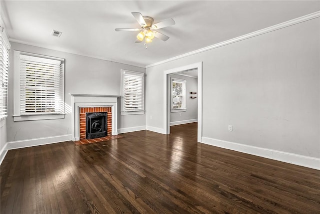 unfurnished living room featuring dark wood-style flooring, visible vents, a brick fireplace, ceiling fan, and baseboards