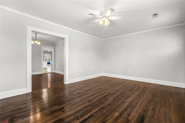 unfurnished room with crown molding, dark wood-style flooring, visible vents, and baseboards