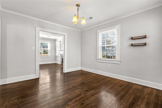 unfurnished dining area with baseboards, visible vents, ornamental molding, dark wood-style flooring, and a chandelier