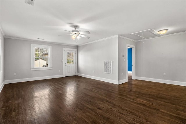 interior space featuring dark wood-type flooring, visible vents, a ceiling fan, baseboards, and attic access