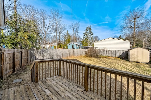 deck featuring a storage shed, a yard, an outdoor structure, and a fenced backyard