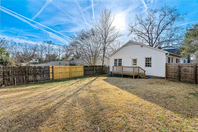 view of yard with a fenced backyard and a wooden deck