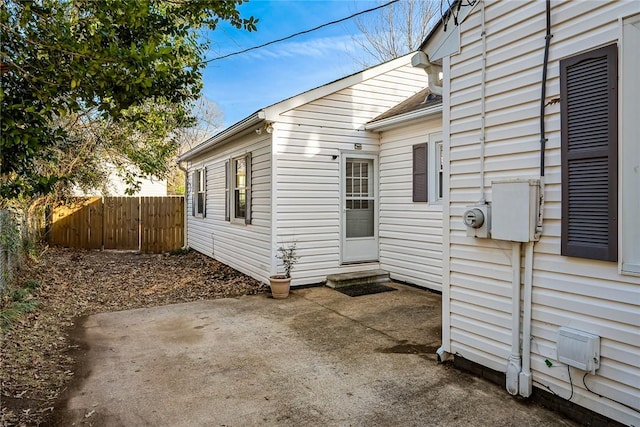 view of home's exterior featuring a patio and fence