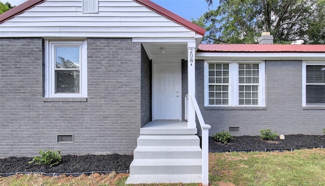 view of front of property with crawl space and brick siding