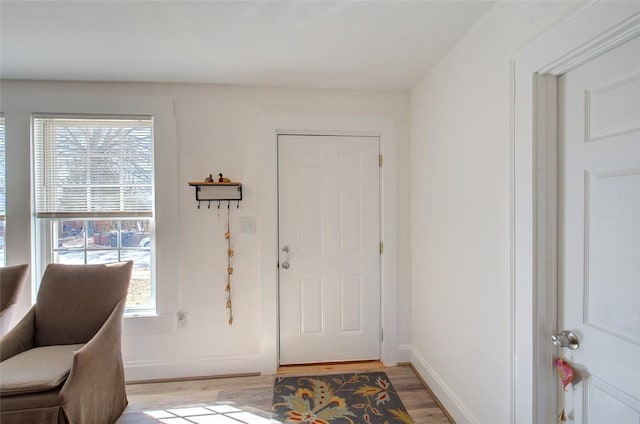 entryway with light wood-style floors and baseboards