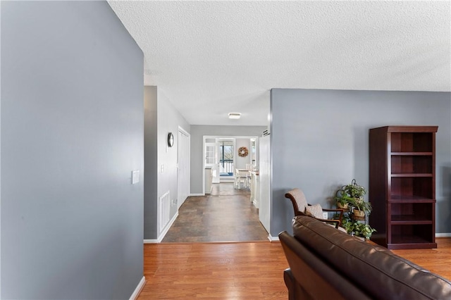 123 Bass Dr, Fair Play, SC 29643 - hall featuring a textured ceiling, baseboards, wood finished floors, and visible vents