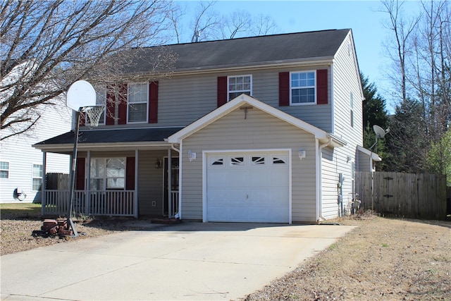 traditional-style home with covered porch, fence, and concrete driveway