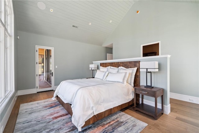 bedroom with light wood finished floors, baseboards, and visible vents