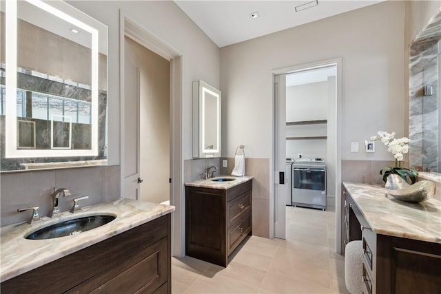 full bath featuring tile patterned flooring, two vanities, and a sink