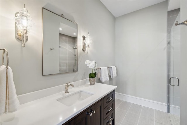 bathroom with tile patterned flooring, a shower stall, vanity, and baseboards