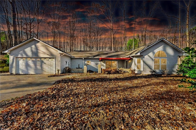 view of front facade featuring concrete driveway and an attached garage