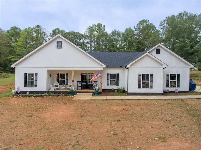 view of front of home with covered porch and roof with shingles