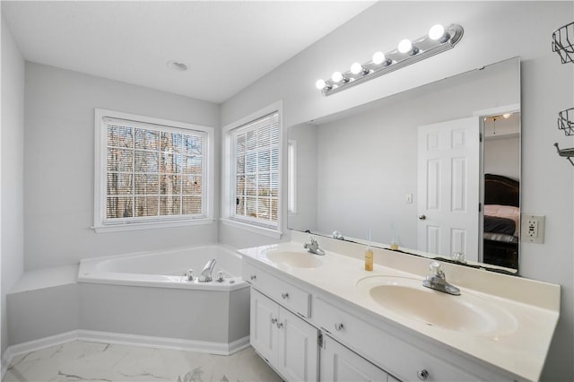 ensuite bathroom featuring marble finish floor, connected bathroom, a sink, and double vanity