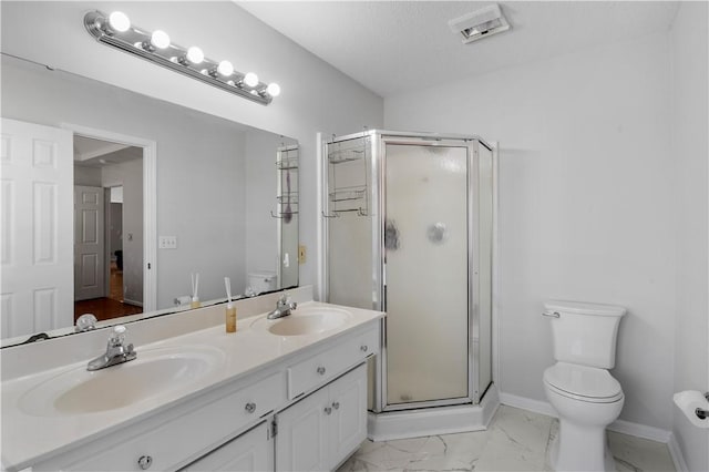 bathroom with marble finish floor, double vanity, a stall shower, and a sink