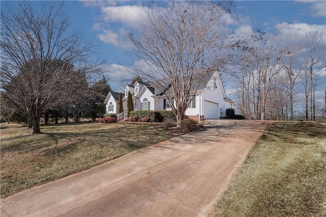 view of front of property with driveway, an attached garage, and a front yard