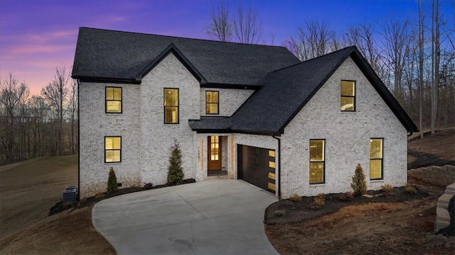 view of front of property featuring driveway, a shingled roof, cooling unit, and brick siding