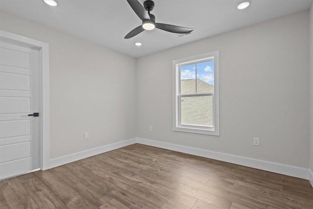 unfurnished room with ceiling fan, recessed lighting, wood finished floors, and baseboards