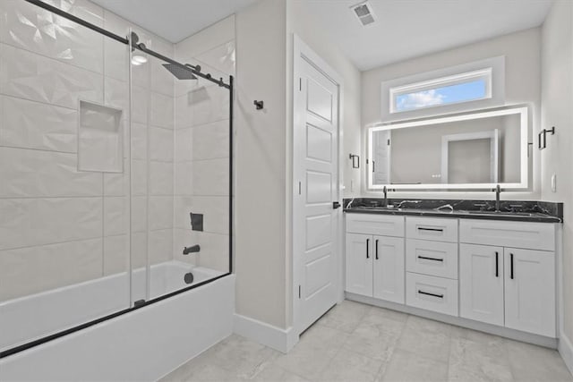 bathroom featuring enclosed tub / shower combo, double vanity, a sink, and visible vents