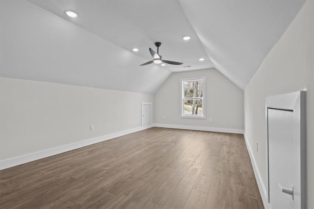 bonus room featuring ceiling fan, vaulted ceiling, baseboards, and wood finished floors