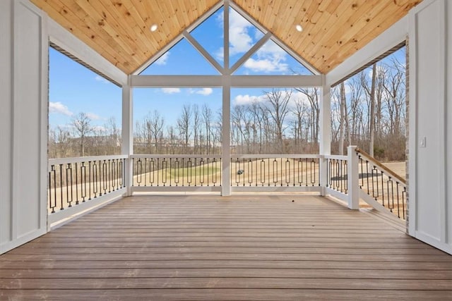 unfurnished sunroom with a wealth of natural light, wood ceiling, and vaulted ceiling