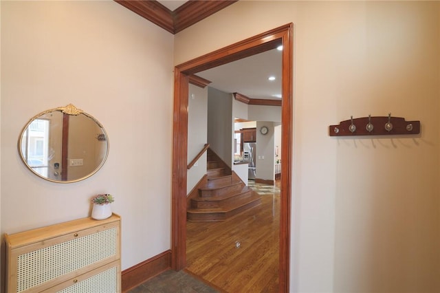 hall with stairway, baseboards, ornamental molding, and wood finished floors