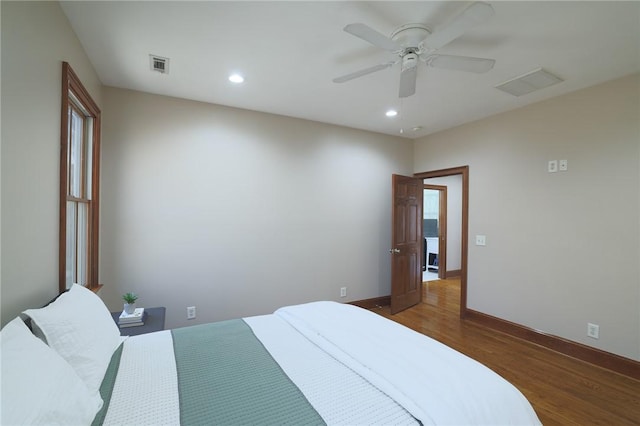 bedroom with recessed lighting, visible vents, and wood finished floors