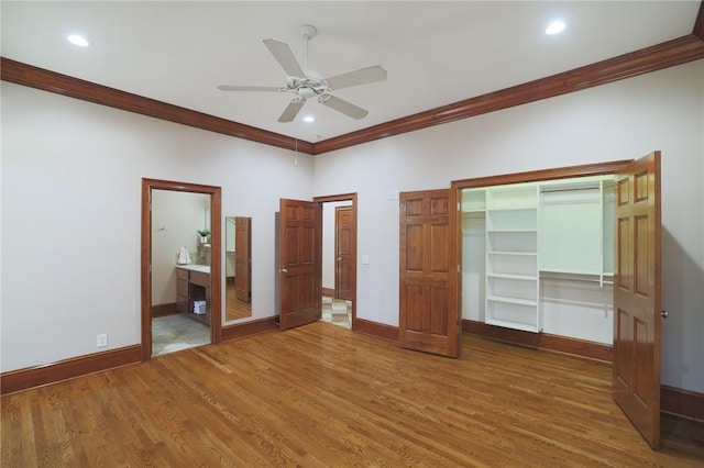 unfurnished bedroom with crown molding, baseboards, and wood finished floors