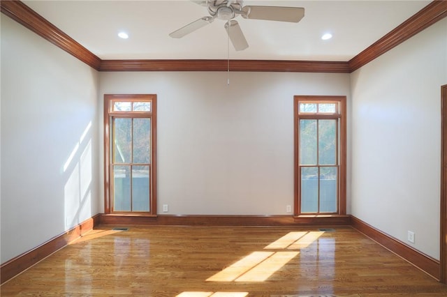 unfurnished room featuring crown molding, wood finished floors, and baseboards