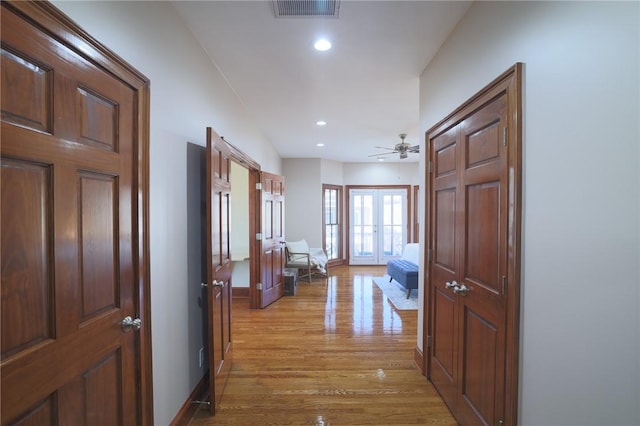 interior space with light wood-style flooring, recessed lighting, visible vents, baseboards, and french doors