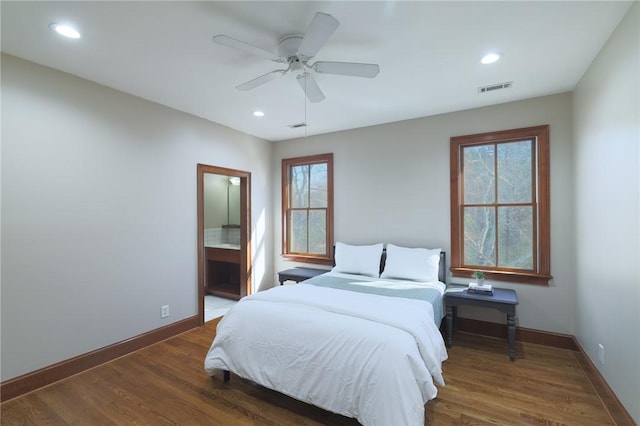 bedroom with recessed lighting, visible vents, baseboards, and wood finished floors