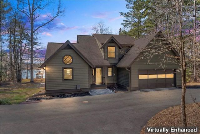 rustic home featuring an attached garage and aphalt driveway