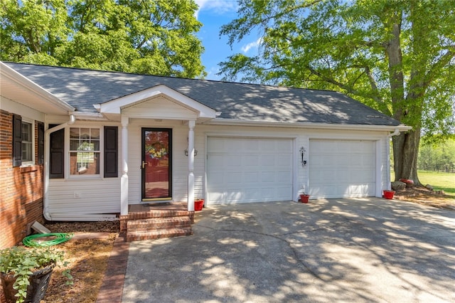 ranch-style house with driveway, a shingled roof, and a garage