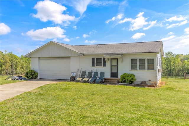 ranch-style home with a garage, a front lawn, and concrete driveway