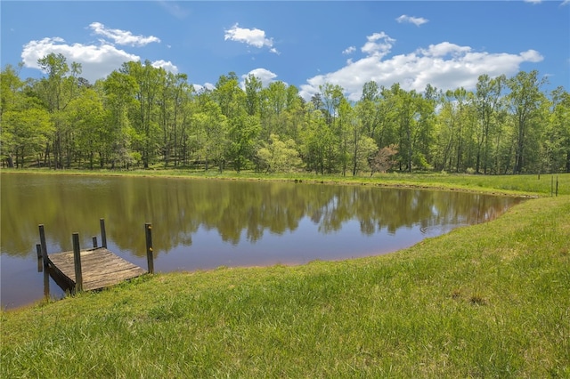 view of dock featuring a water view and a lawn