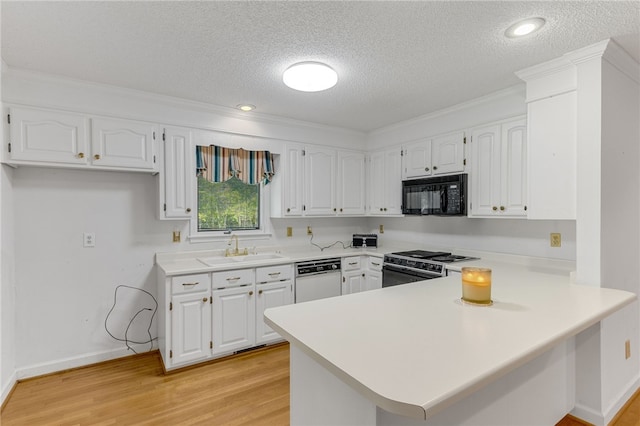 kitchen featuring black microwave, white cabinetry, light countertops, range, and dishwasher