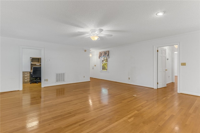 unfurnished living room featuring visible vents, light wood-style flooring, ornamental molding, ceiling fan, and a textured ceiling