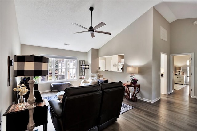 living room with visible vents, dark wood-type flooring, a ceiling fan, high vaulted ceiling, and baseboards