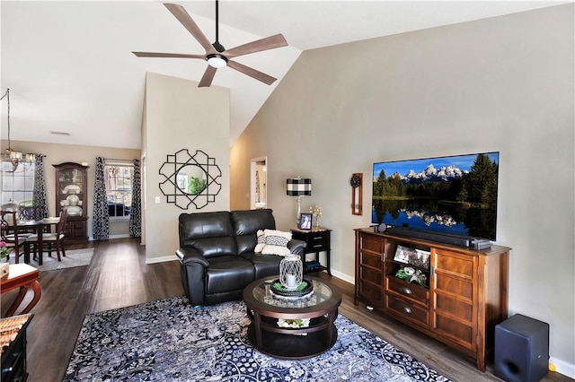 living area with high vaulted ceiling, ceiling fan, baseboards, and wood finished floors