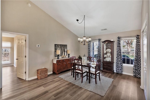 dining space featuring a chandelier, dark wood-style flooring, visible vents, and baseboards