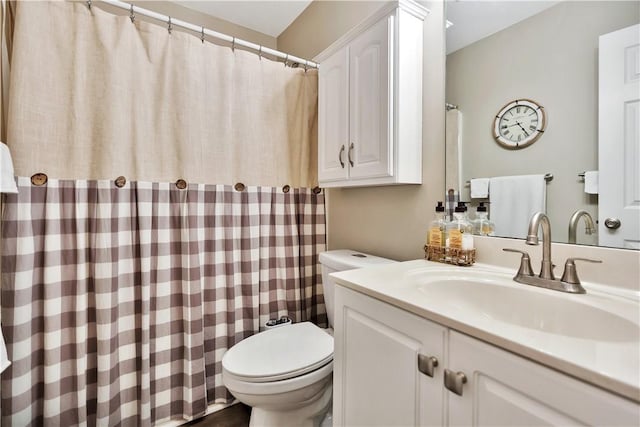 bathroom featuring a shower with shower curtain, vanity, and toilet