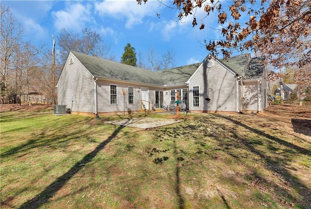 back of property with a patio area, central AC, and a yard