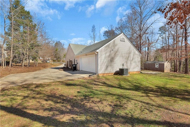 view of home's exterior with a lawn, central AC unit, a shed, driveway, and an outdoor structure